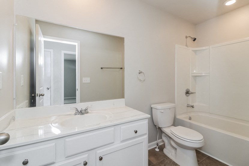 a bathroom with a sink toilet and a mirror