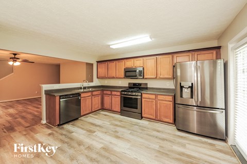 A kitchen with wooden cabinets and stainless steel appliances.