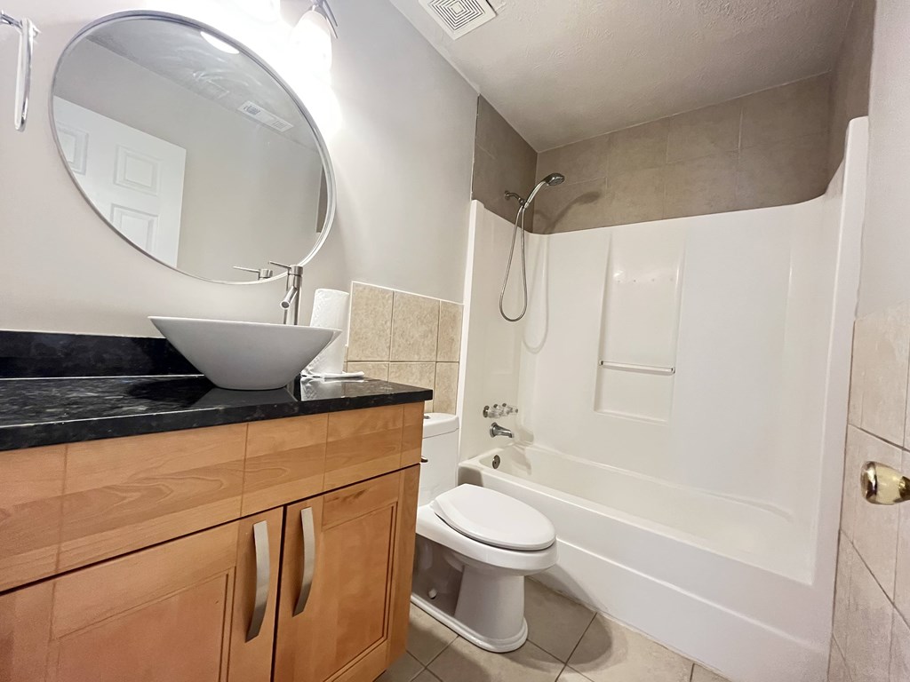 a bathroom with a sink and a toilet and a shower