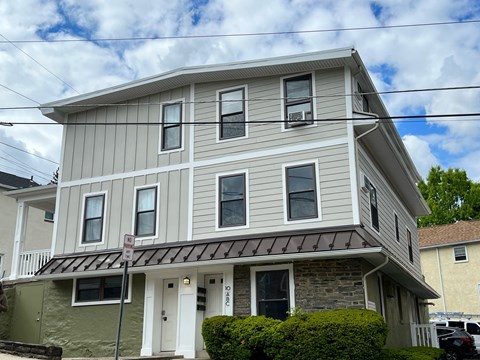 A two-story house with a grey and white exterior.