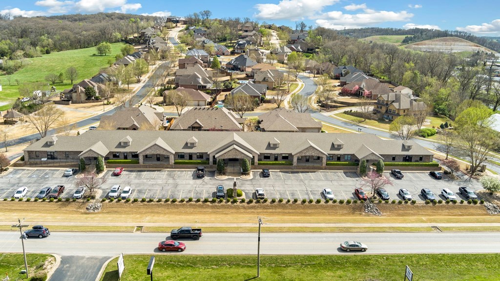 A suburban neighborhood with houses and cars parked in the driveways.