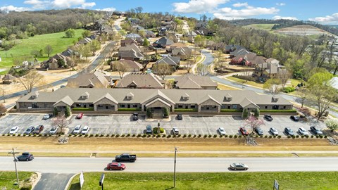 A suburban neighborhood with houses and cars parked in the driveways.