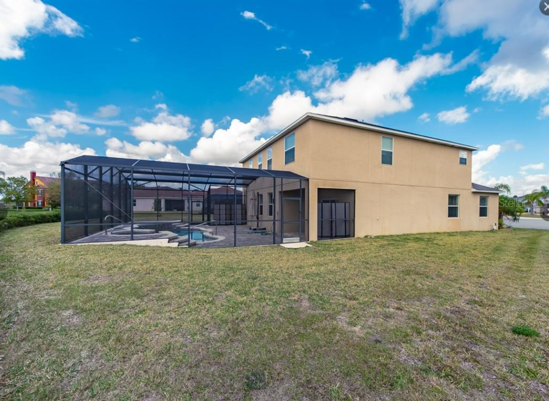 a house with a pool and a glass enclosure
