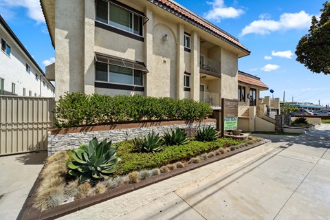 A building with a brown roof and a sign in front of it.