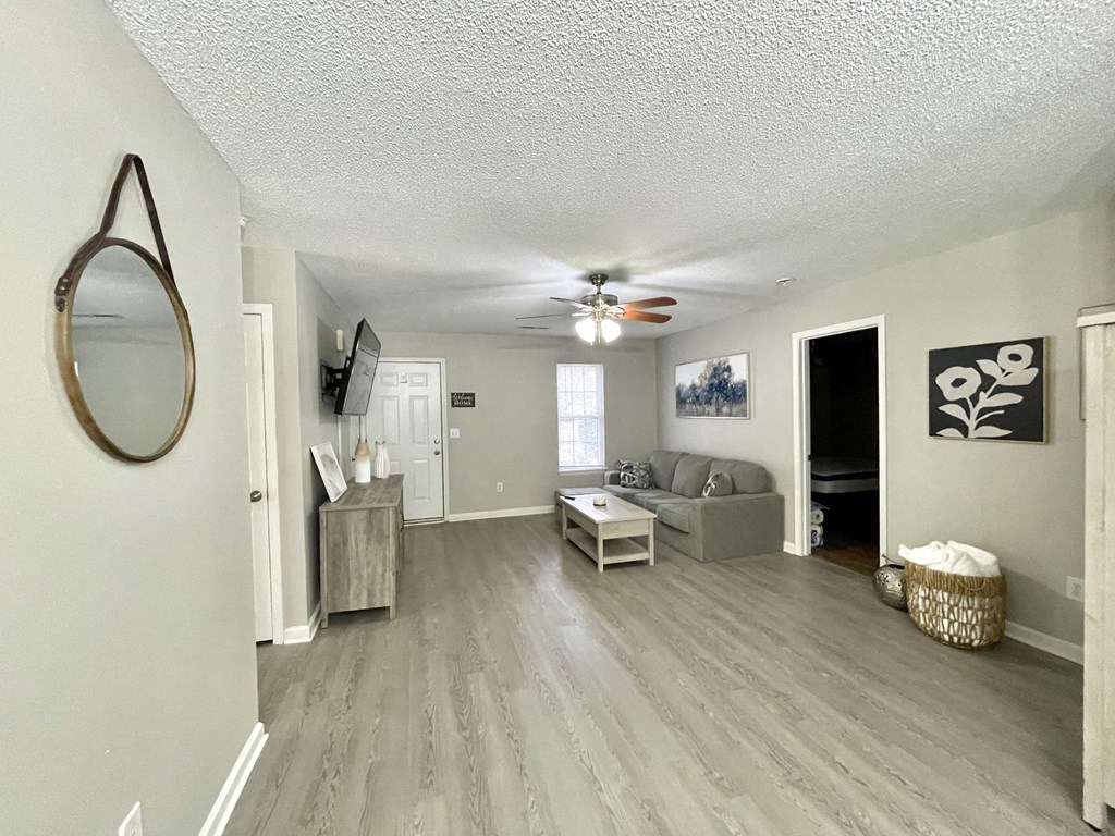 a living room with a couch and a ceiling fan