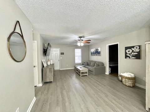 a living room with a couch and a ceiling fan
