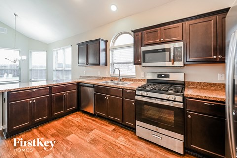 a kitchen with wooden cabinets and stainless steel appliances
