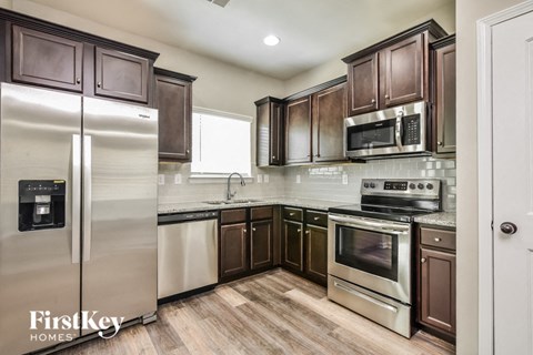 a kitchen with stainless steel appliances and wooden cabinets
