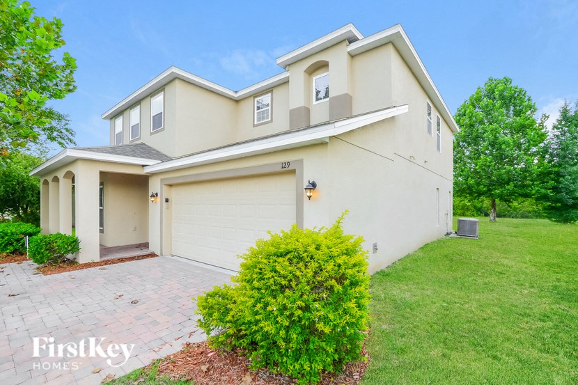a white house with a driveway and a garage door