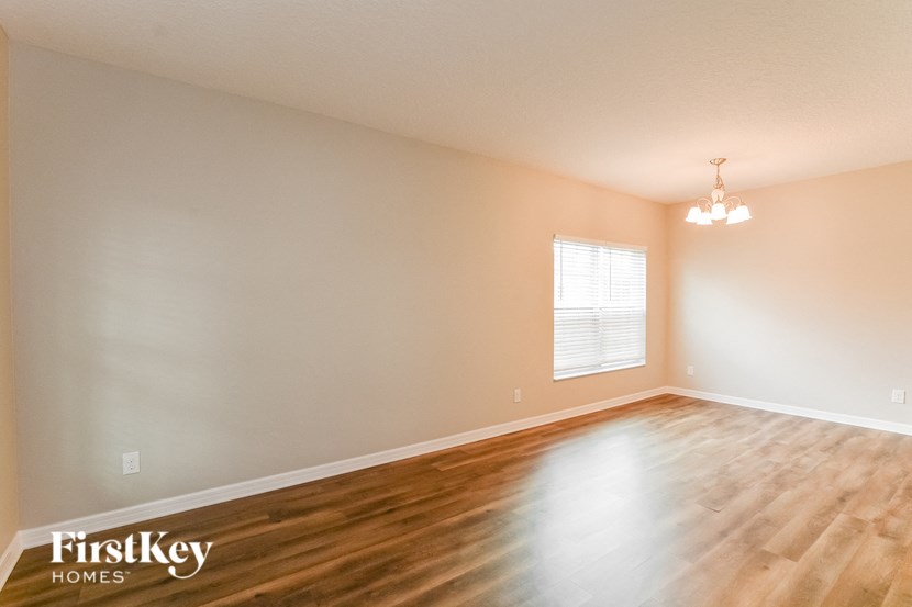 a living room with a hard wood floor and a window