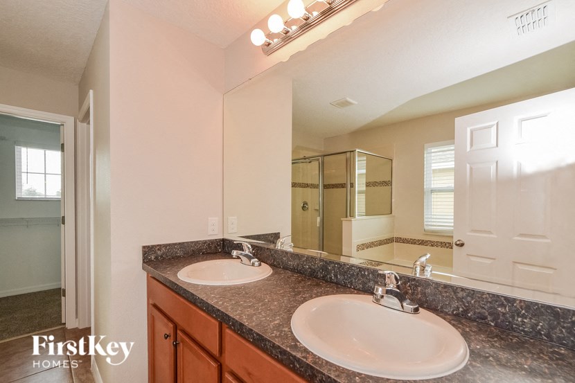 a bathroom with two sinks and a large mirror