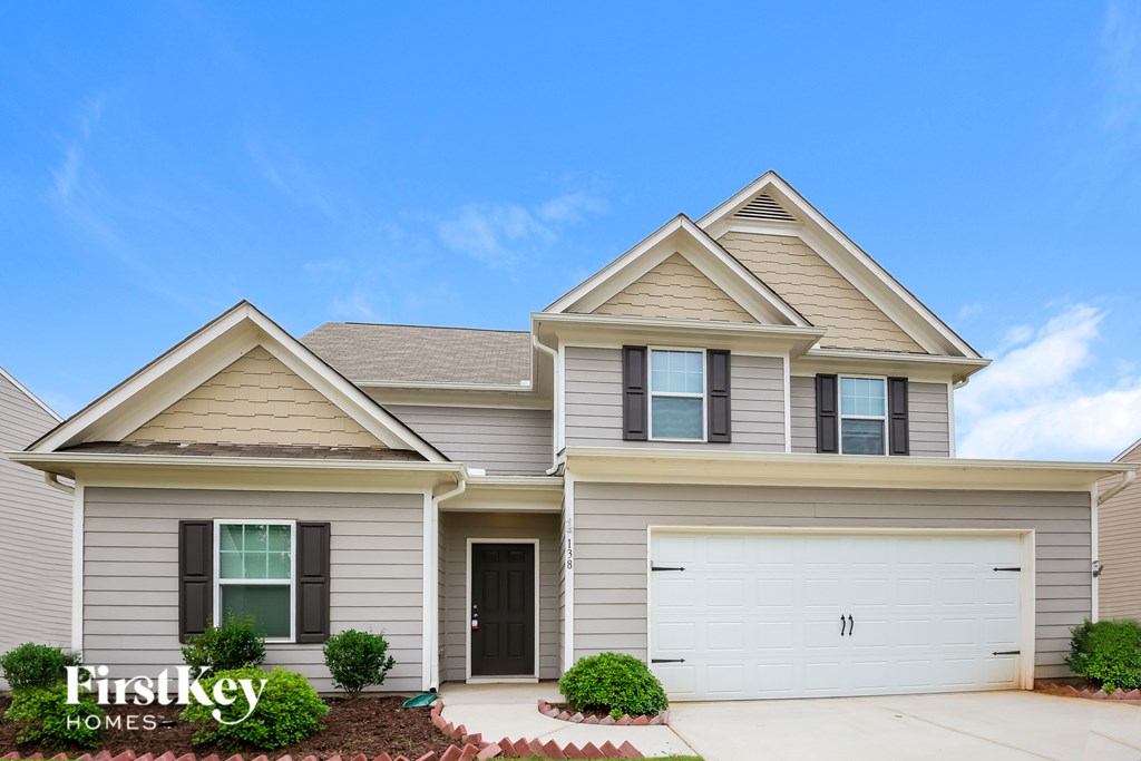 A two-story house with a garage is for sale by FirstKey Homes.