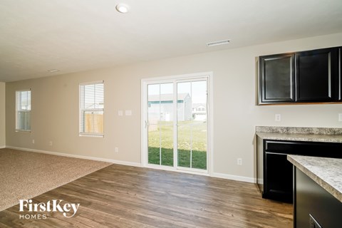 A kitchen with a black fridge and a white counter top.