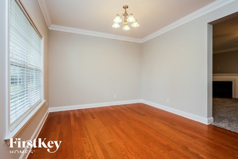 a living room with a wood floor and a large window
