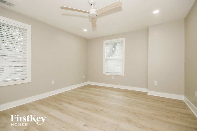 the living room with hardwood floors and a ceiling fan