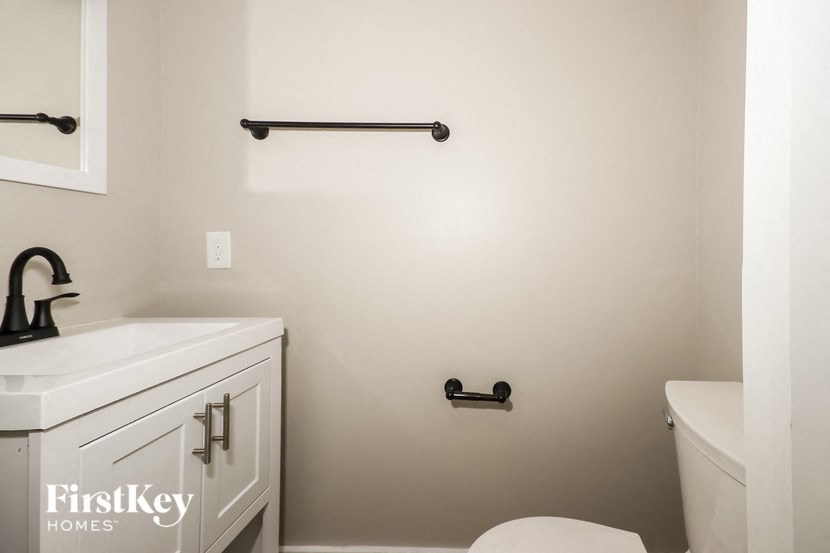 a white bathroom with a toilet and a sink