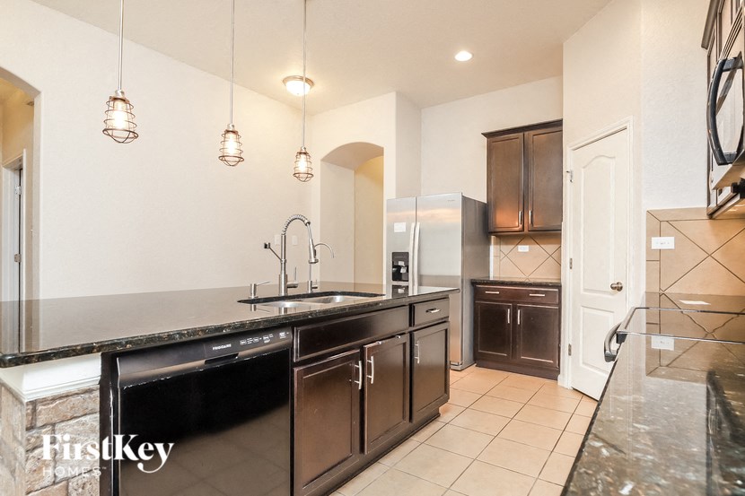 a kitchen with stainless steel appliances and a large counter top