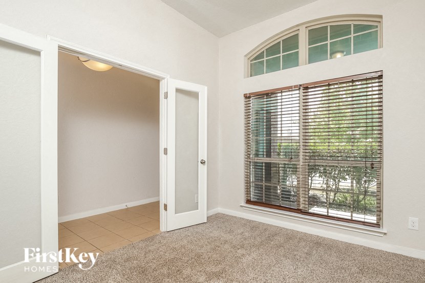 a room with a large window and a door to a closet