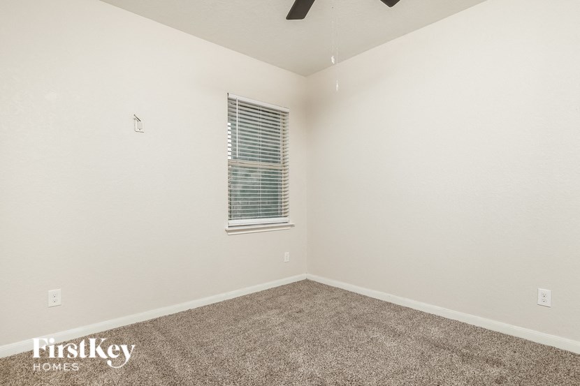 the upstairs bedroom with carpet and window