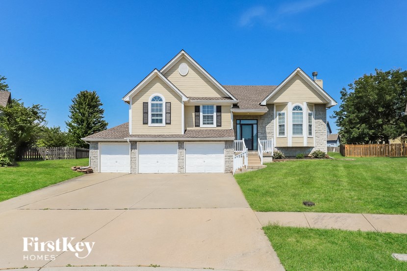 a suburban house with a driveway and a lawn