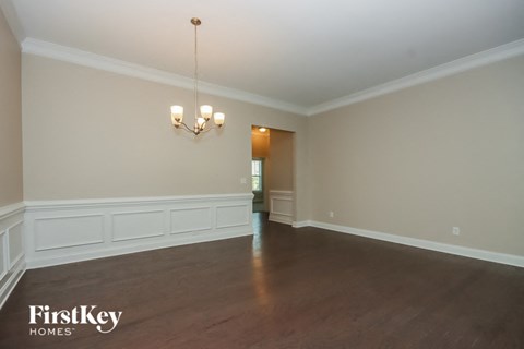 an empty living room with white walls and wood floors