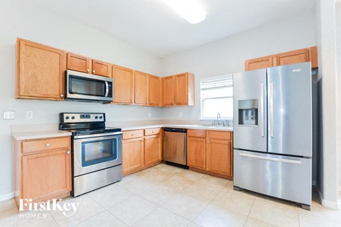 a kitchen with stainless steel appliances and wooden cabinets