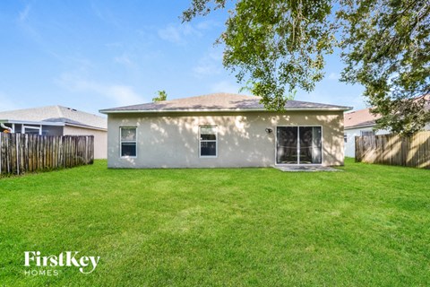 a backyard with a small house and a yard with grass