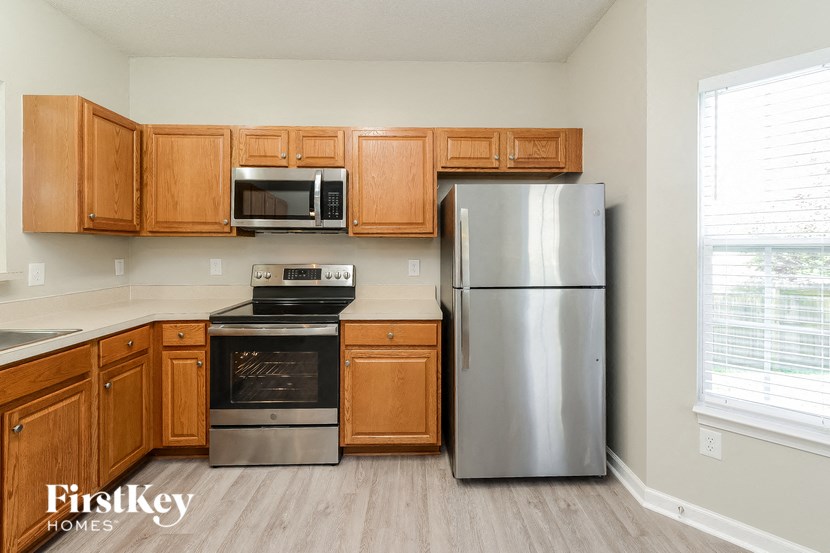 a kitchen with stainless steel appliances and wooden cabinets