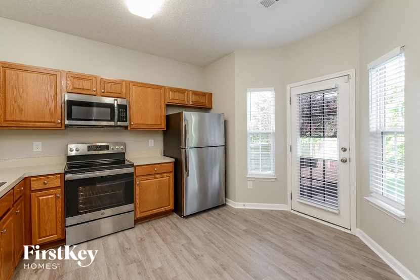 a kitchen with wooden cabinets and stainless steel appliances