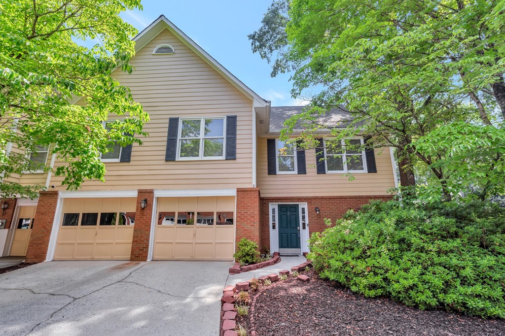 a house with a driveway and two garage doors