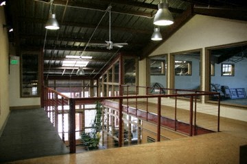 A room with a balcony and a ceiling fan.