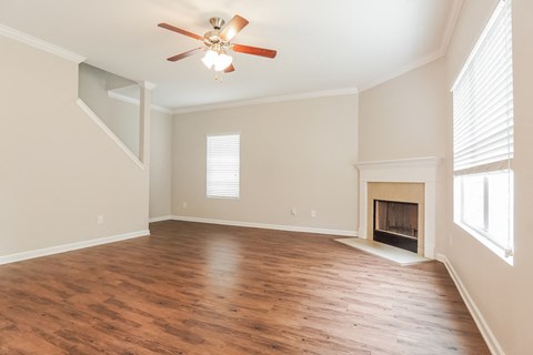 A room with a fireplace and a ceiling fan.
