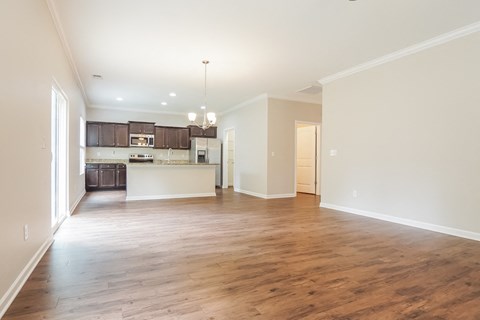 A spacious kitchen with wooden floors and a large island.