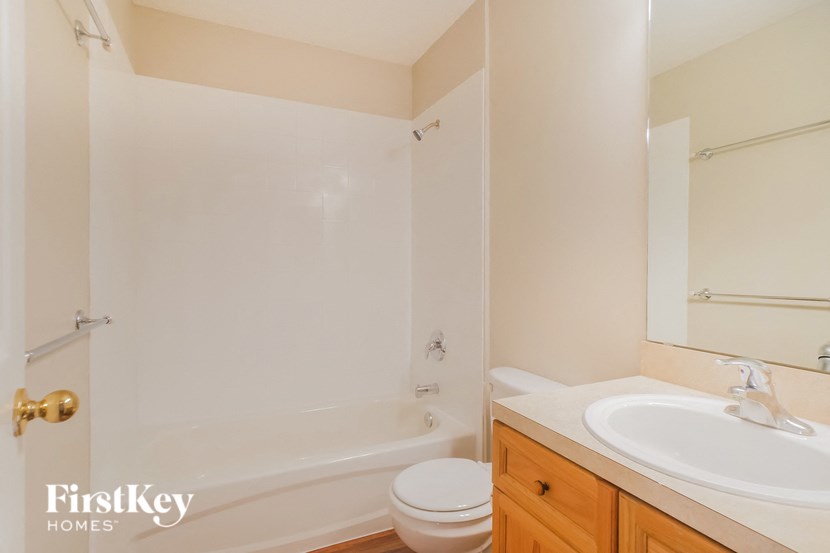 a bathroom with a toilet and a sink and a shower