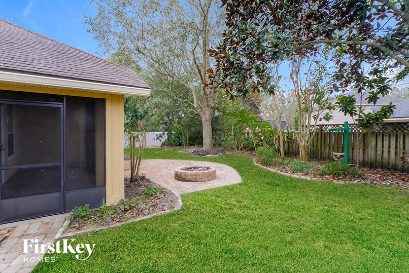 a backyard with a patio and a fire pit