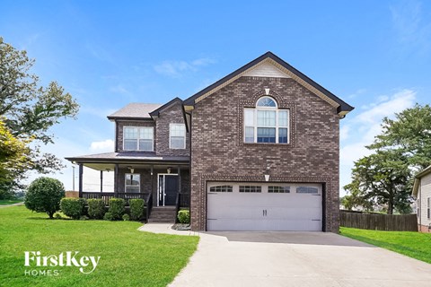 A brick house with a garage door and a driveway.