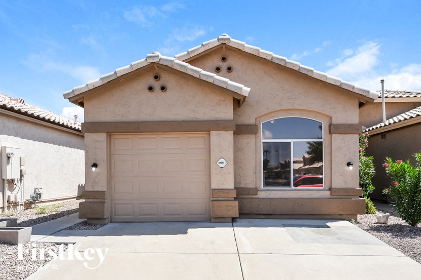 a house with a white garage door and a window