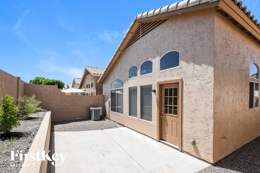 a building with a door and a sidewalk in front of it