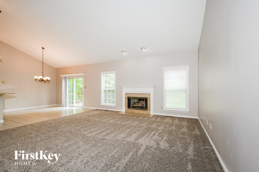 a living room with a fireplace and a rug