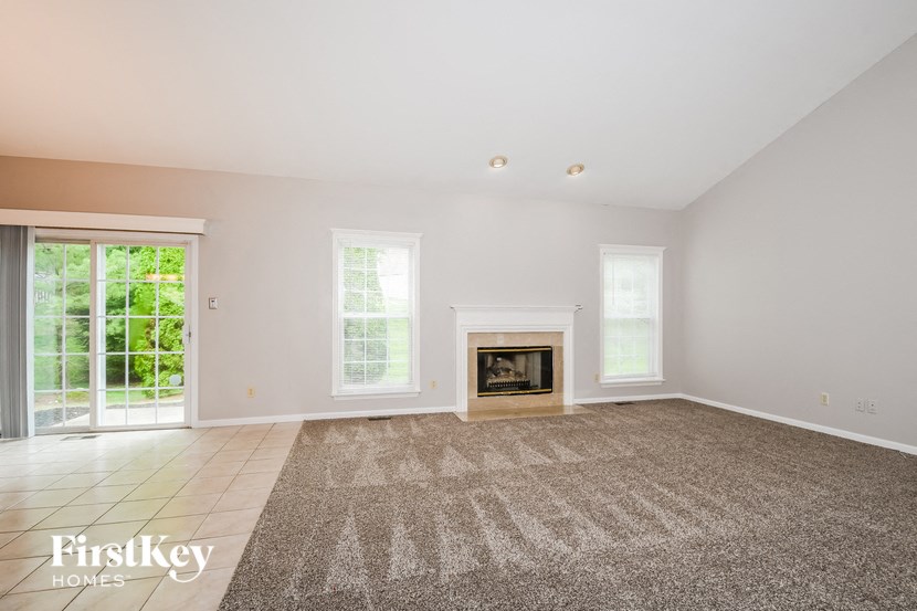 a living room with a fireplace and a rug
