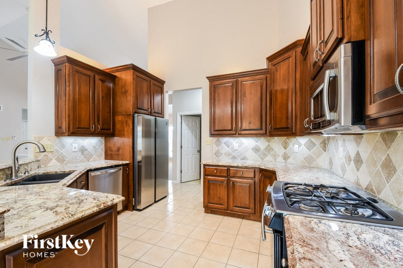 a kitchen with wooden cabinets and stainless steel appliances