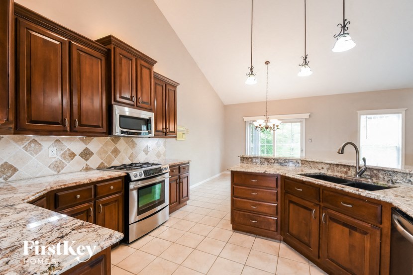 a kitchen with wooden cabinets and a stove and a sink