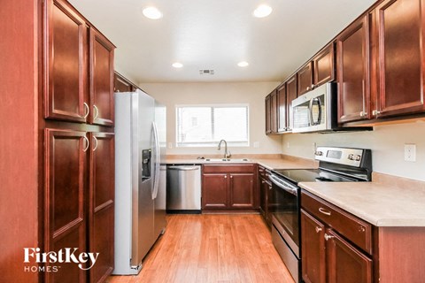 a kitchen with wooden cabinets and stainless steel appliances