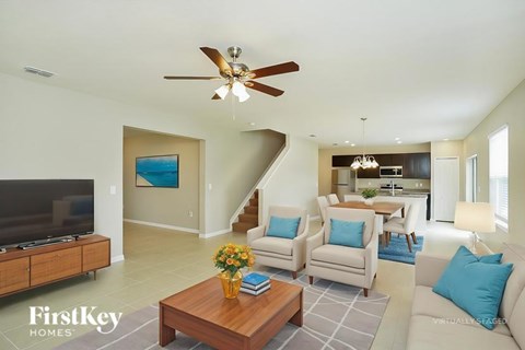 A living room with a brown coffee table and a white couch.