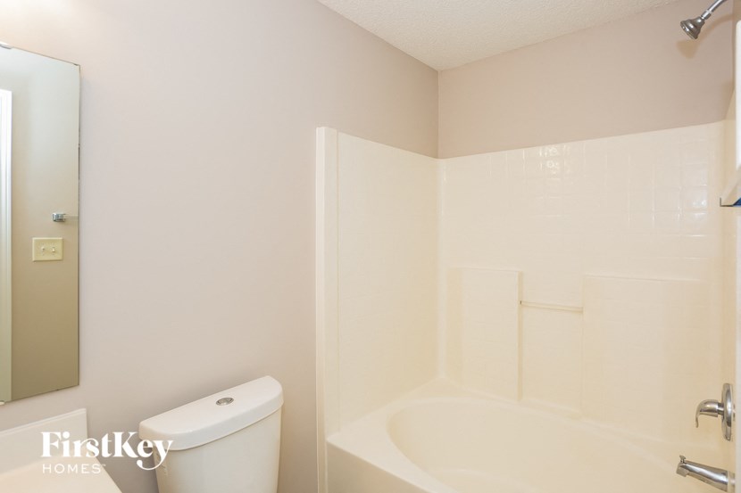 a white bathroom with a toilet and a sink