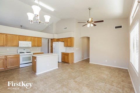 A kitchen with wooden cabinets and a white refrigerator is shown.