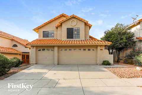 a house with a garage and a driveway in front of it