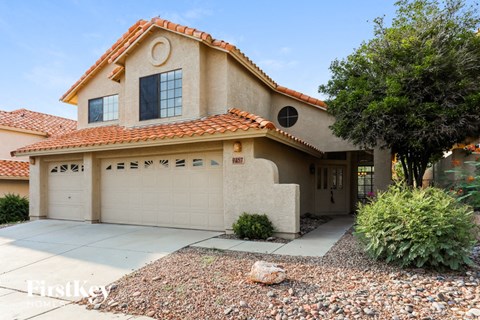 a house with a garage door and a driveway