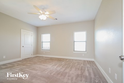 the second bedroom is spacious and has a ceiling fan