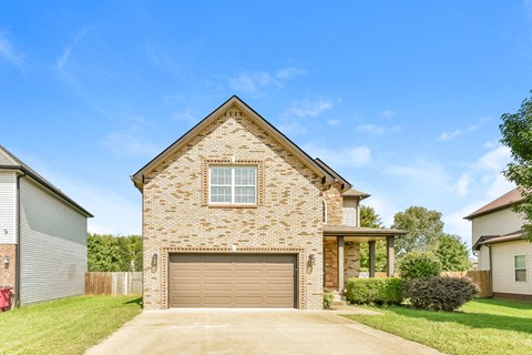 A house with a garage door and a window is shown.